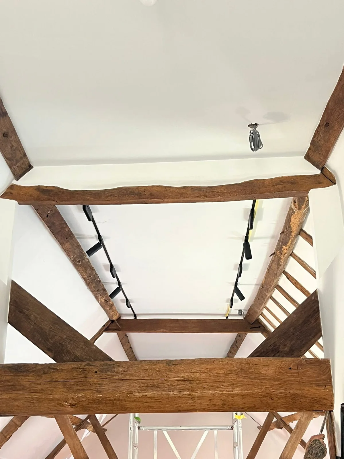 Bathroom renovation in progress with exposed beams